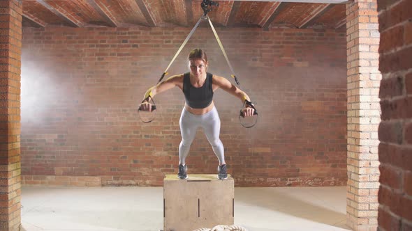 Exercise With Hanging Straps Trx. Girl Engaged in Sports Tight in Gym on Belt Trx.