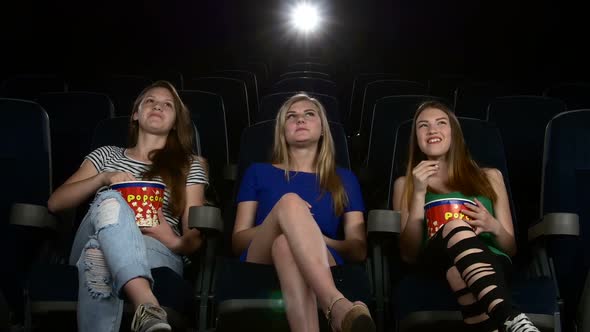 Cute Girl Watching Movie in Cinema Theater. and Eating Popcorn