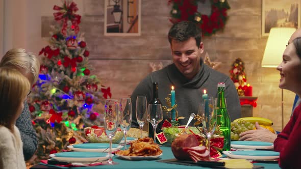 Happy Family While Young Mother Serves Tasty Chicken