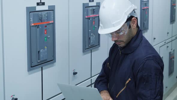 Worker in electrical control room