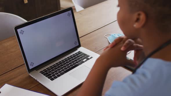 African american female doctor having video call consultation using laptop with copy space