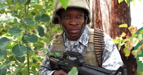 Military soldier guarding with a rifle alt