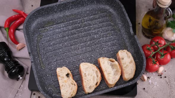 Toasting Slices of Baguette in a Grill Frying Pan