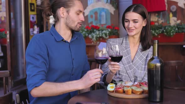 Couple Drinking Wine Enjoying Romantic Dinner At Restaurant