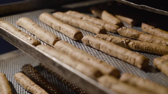 The Process of Baking Bread Sticks on Plates in Professional Oven