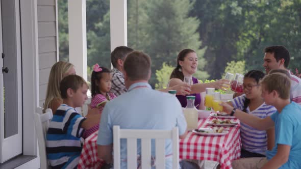 Group of people eating and enjoying a backyard barbeque