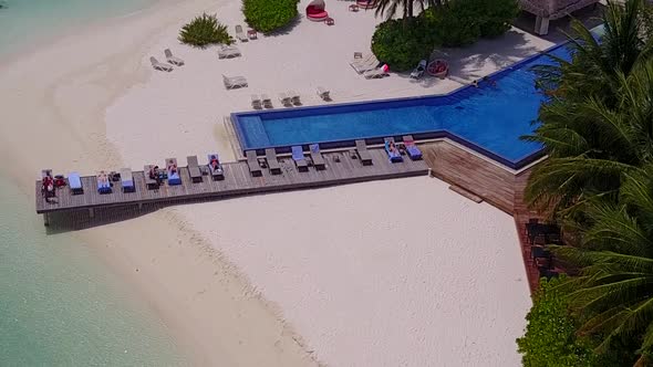 Aerial drone seascape of coastline beach by blue lagoon with sand background