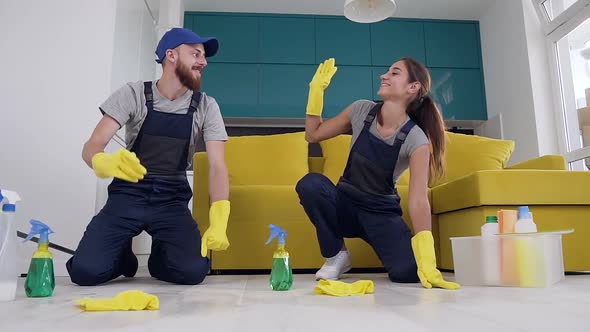 Happy Young People of the Cleaning Company Giving High Five