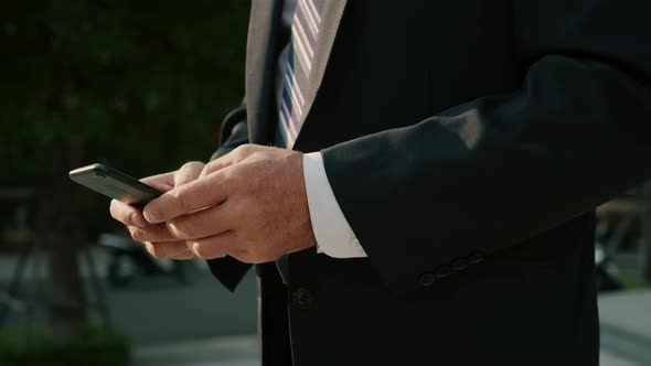 Male Reading Phone Message or Downloading an App for His Mobile Phone