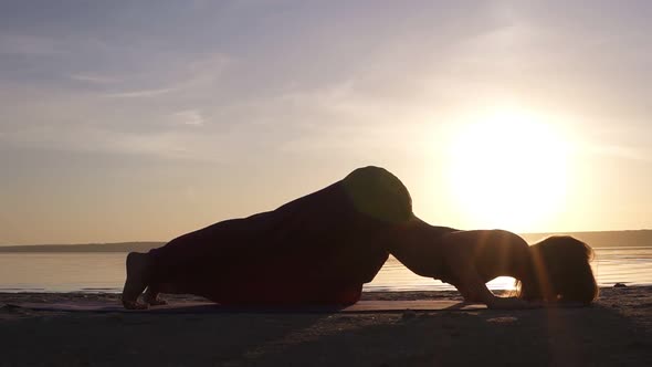 Beautiful Footage on Sunset Beach Woman Doing Yoga Asana on a Mat Backbend Urdhva Mukha Shvansana