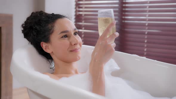 Closeup Young Happy Relaxed Woman Relaxes in Foam Bath Drinking Wineglass Champagne Enjoys Fragrant