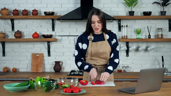Woman listen chef study online video call sliced bell pepper on cutting board
