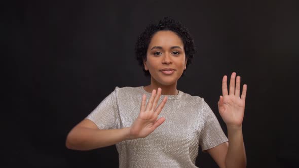 Happy Young Woman Dancing Over Black Background