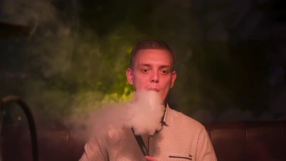 Man producing rings of smoke