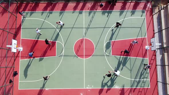 Men Play Streetball at Outdoor Court Aerial View