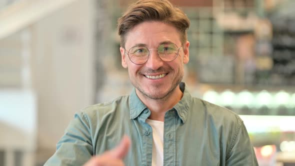 Portrait of Positive Middle Aged Man Doing Thumbs Up