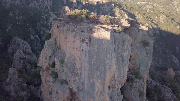 Aerial shoting up while panning down on the massive castle-like crag Chateau fort