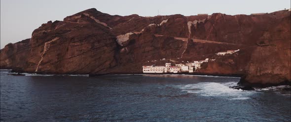 Aerial shot of a white house village by the coast