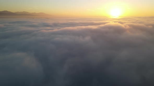 Aerial of the sunrise above the clouds