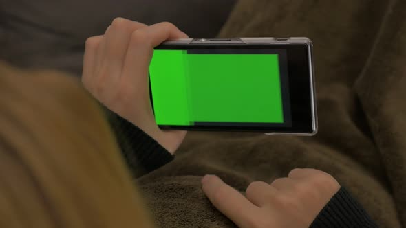 Changing content mobile phone green screen display 4K 2160p UHD video - Woman holding smart phone wi