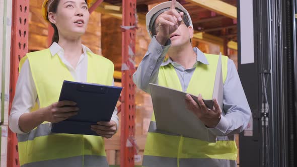 asian Male and Female Industrial Engineers in Hard Hats