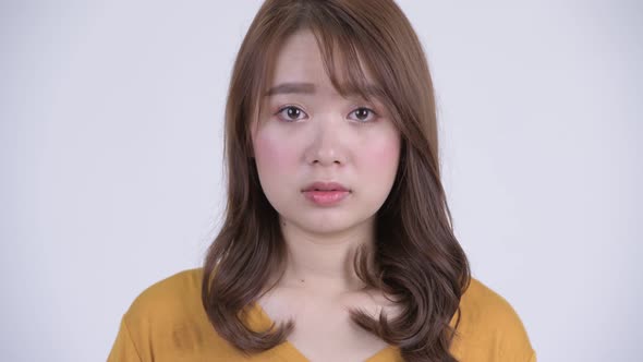 Face of Young Asian Woman Looking at Camera