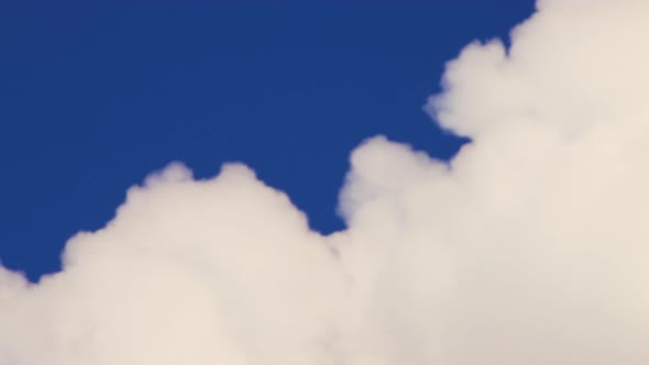 Dense White Clouds Against the Blue Sky As Fastmoving Smoke From a Chimney