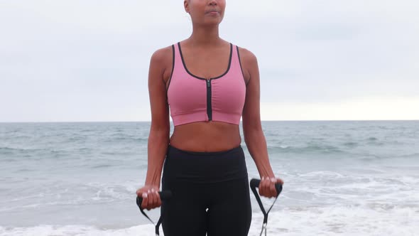 Mixed ethnicity woman exercising at the beach