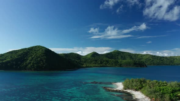 Rising aerial of stunning tropical mountain range in Fiji, paradise coastline