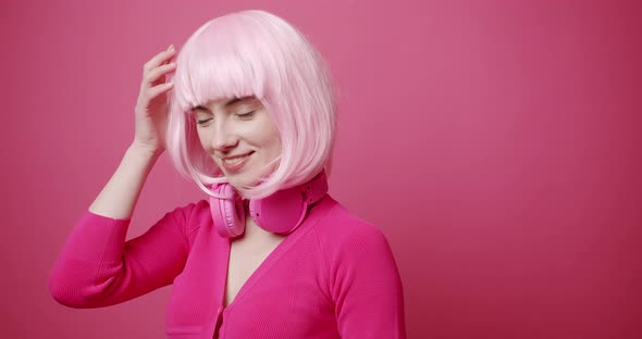 Beauty Woman with Beautiful Eyes Pink White Hair and Pink Clothes Arranges Hair