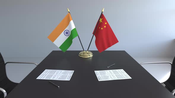 Flags of India and China and Papers on the Table