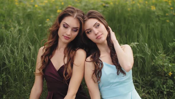 Spring Beauty Portrait of Two Women on the Green Nature Background