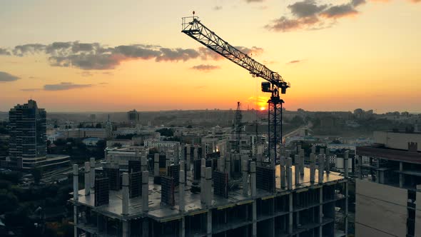 Urban Landscape at Sunset with Houses Getting Built, Construction Site at a Sunset alt