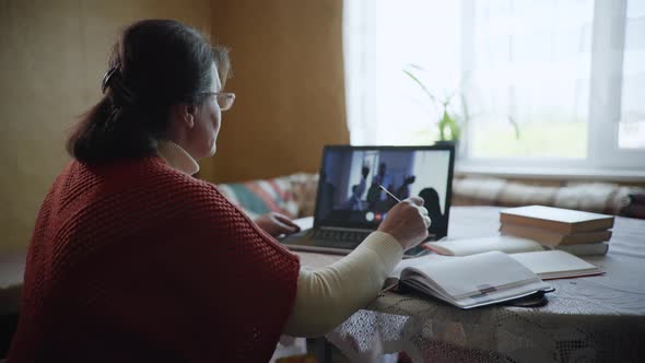 Distance Learning, an Elderly Modern Woman a Pensioner Masters a Modern Profession with Help of