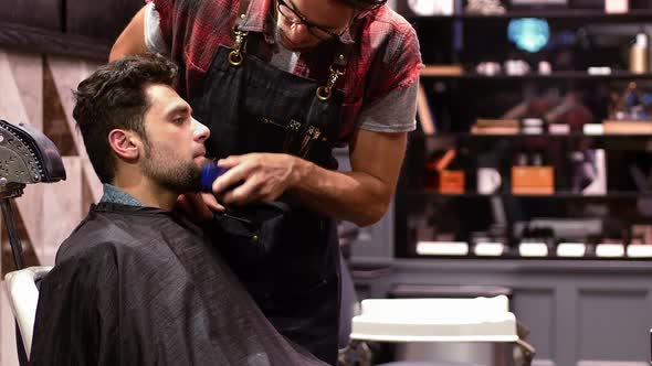 Man getting his beard trimmed with trimmer