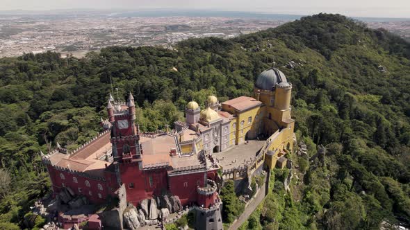 Colourful Pena Palace And National Park In Sintra, Portugal. Aerial orbiting shot