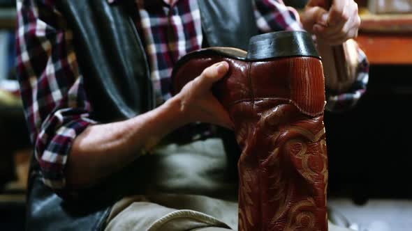 Shoemaker hammering on a shoe