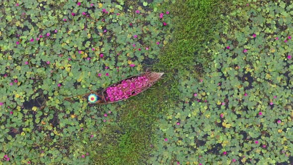 Aerial view of a fisherman working on a small canoe, Dhaka, Bangladesh.