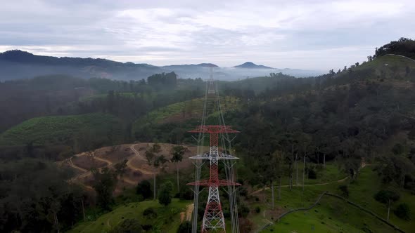 Aerial view electric tower at plantation at hill