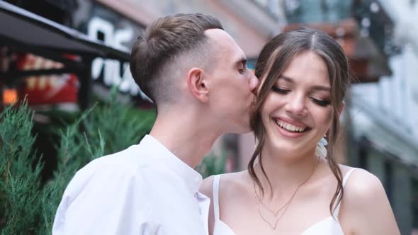 Happy Husband Kisses His Wife on the Cheek