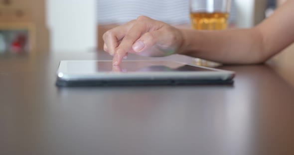 Close up of woman use of tablet computer at home