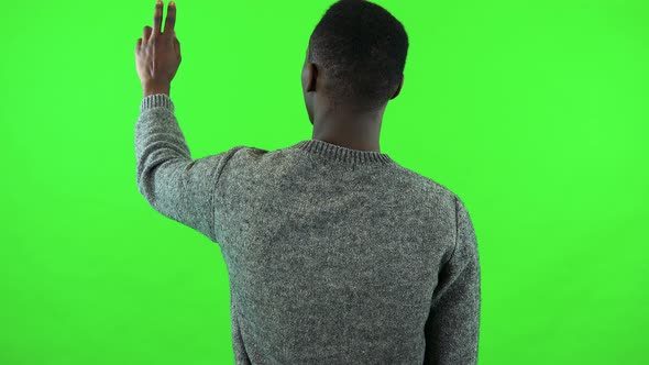 A Black Man Works on an Interactive Board - Green Screen Studio