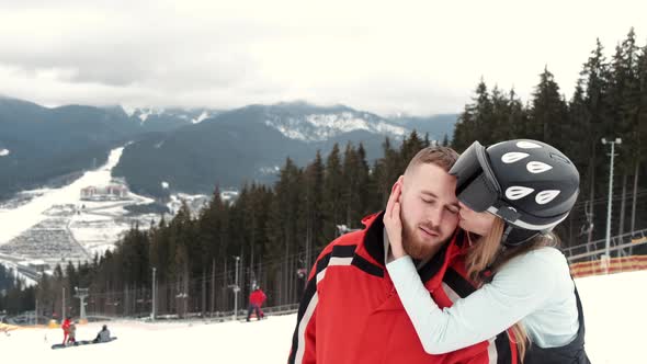 Loving Couple in Sporty Wearing on Mountain at Ski Resort