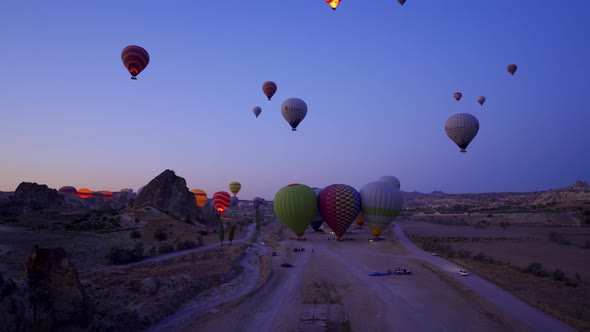 Aerial shot of many hot air balloon flying over idyllic Love Valley in natural park in Cappadocia