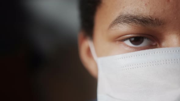 African American Teenager Wearing Backpack and Facial Mask to Protect Himself From Coronavirus