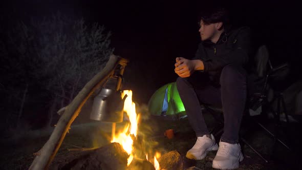 Camper by the fire, night camp.