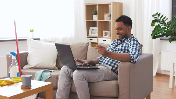 Man with Laptop Shopping Online After Cleaning 17