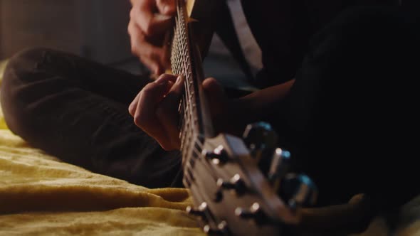 Crop Teen Guitarist Rehearsing in Evening