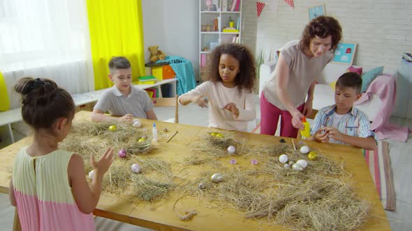 Multi-ethnic Children Decorating Easter Eggs in Art Class alt