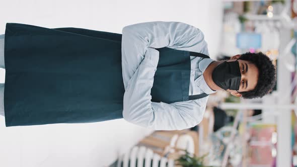 Vertical View African Guy Worker in Apron Posing with Crossing Hands Looking at Camera Indoor